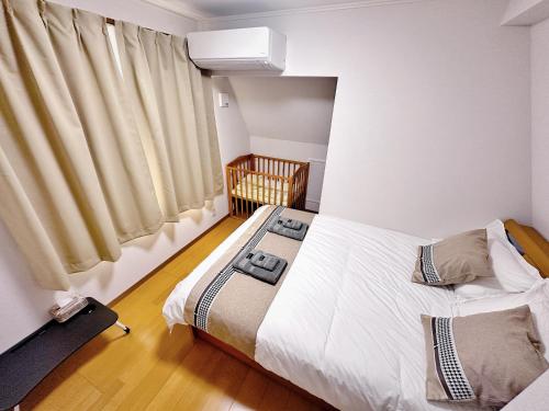 a bedroom with two beds and a window at Ueno 10minutes, Tokyo University 10minutes, three BR, three toilets, Max 10 people Free parking in Tokyo
