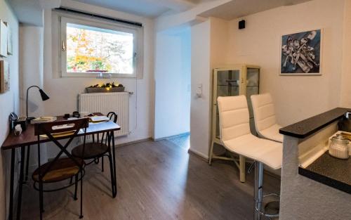 Ferienwohnung Rath في كولونيا: مطبخ وغرفة معيشة مع طاولة