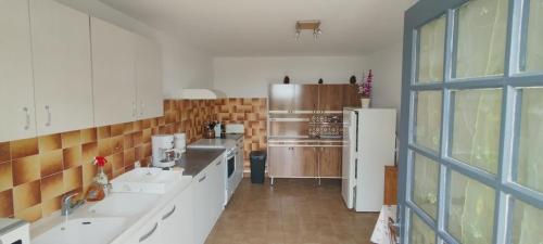 a kitchen with two sinks and a refrigerator at Gîte des deux Moulins en Périgord Vert in Grand Brassac