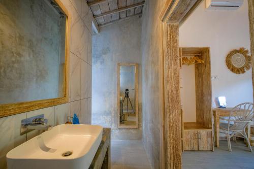 a bathroom with a sink and a mirror at Drift Hideaway- Adult only in Kuta Lombok