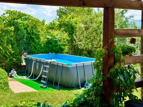 a swimming pool in a yard with at Pensiunea Carmen - Bikers Friendly Nest in Sibiu