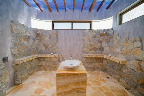 a stone bathroom with a sink and a stone wall at Koh Chang Grandview Resort in Ko Chang