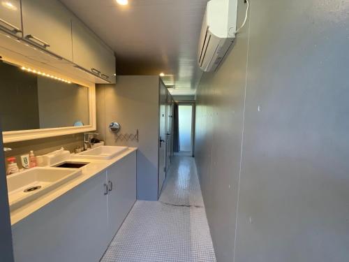 a bathroom with two sinks and a mirror at スパイス平戸 in Hirado