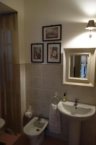 a bathroom with a sink and a mirror at A Casa di Amelie in Palermo