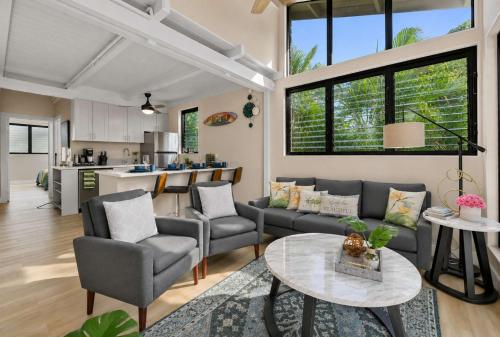 a living room with a couch and a table at Coral Cove-Poolside Condo and Panoramic Ocean View in Kahana