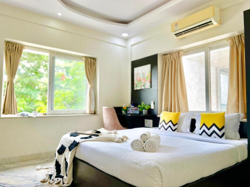 a bedroom with a large bed with towels on it at BluO Lake View NewTown - Boutique Hotel in Kolkata