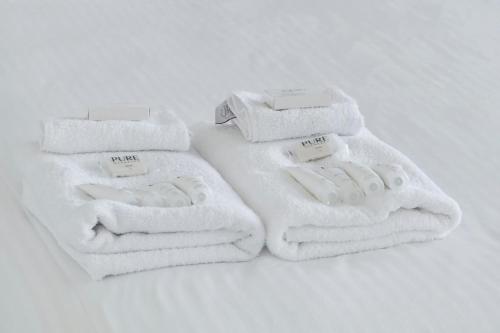 a pile of white towels sitting on a table at Bondi Beach Escape, Steps to Sand & Cafe in Sydney