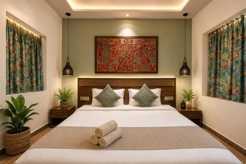 a bedroom with a large bed with towels on it at Rumis Jaisalmer in Jaisalmer