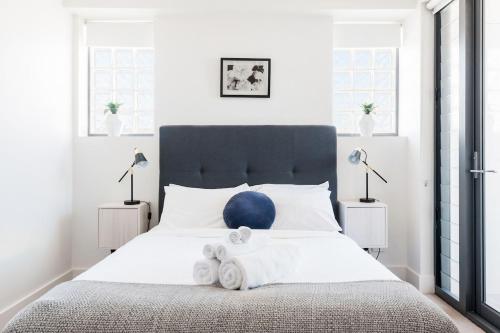 a bedroom with a large bed with a blue ball on it at Cozy Bondi Apartment Heated Winter Stay in Sydney