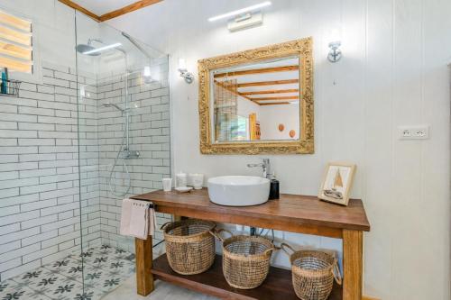 a bathroom with a sink and a mirror at Breeze Ocean Bungalow Moorea in Moorea