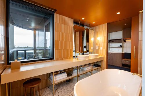 a bathroom with a large window and a tub at Hotel Panorama in Clapham