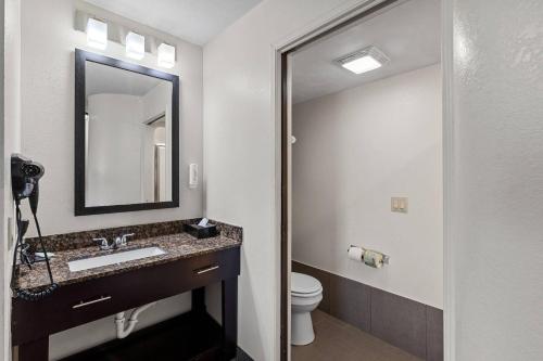 a bathroom with a sink and a toilet and a mirror at Sleep Inn Beaufort near MCAS in Beaufort