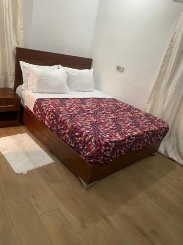 a bed sitting in a bedroom with at TchaoPremium in Lomé