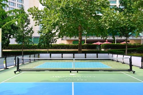 a tennis court with a net on a court at JW Marriott Hotel Beijing in Beijing