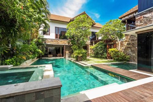 a swimming pool in the backyard of a house at Villa Yasmin in Seminyak