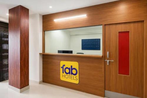 a sliding door with a tubo hooters sign on it at FabHotel Silver Star in Pune