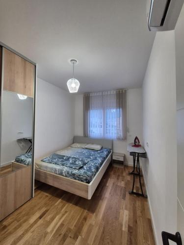 a bedroom with a bed and a mirror in it at Family Home Apartment in Bar