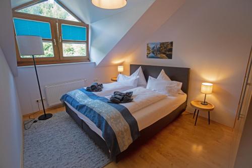 a bedroom with a bed in a room with a window at Ferienwohnung Marienhof in Bad Aussee