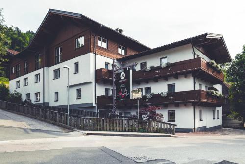 a white and brown building with balconies on it at Die Barbara Appartements & Zimmer in Schladming