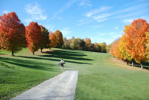 a person walking down a road in a field at Four Chimneys Inn in Bennington