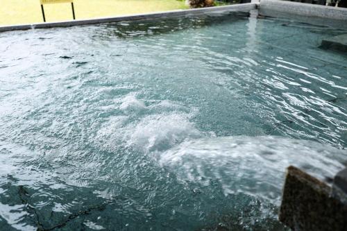 a pool of water in a swimming pool at Yuhigaura Onsen Ryotei KAI in Kyotango