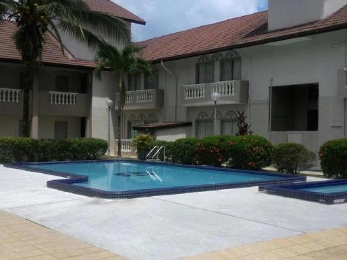 a swimming pool in front of a building at Hotel Seri Malaysia Taiping in Taiping