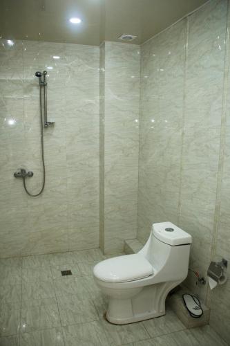 a bathroom with a toilet and a shower at Mirage Hotel in Yerevan