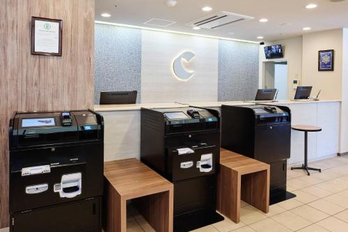 a check in counter with two atm machines in a store at Comfort Hotel Sendai East in Sendai