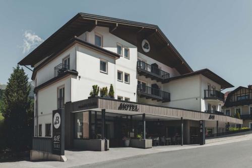 a large white building with a black roof at B&B Hotel Die Barbara in Schladming