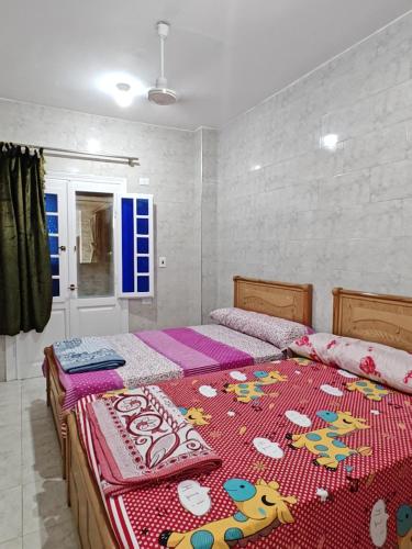 two beds sitting next to each other in a bedroom at See you soon blue Beach in Marsa Matruh