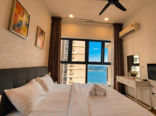 a bedroom with a bed with a large window at Amberside Coastal Breeze Oasis in Johor Bahru