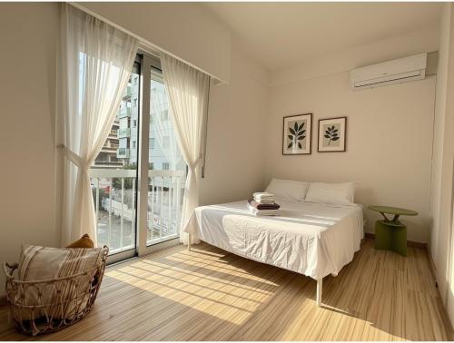 a bedroom with a bed and a large window at Nicosia Neoclassic Retreat in Nicosia