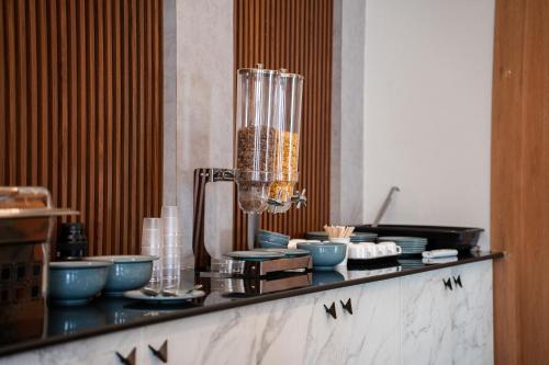 a counter with a bunch of bowls and a blender at 23 Urban Square in Hyderabad