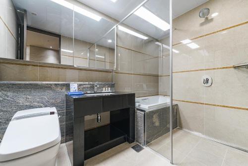 a bathroom with a toilet and a sink and a shower at Le Collective Busan station in Busan