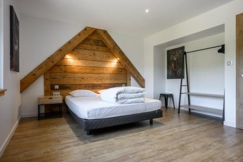 a bedroom with a bed with a wooden ceiling at Gîte Perce Neige, Spa, Sauna in Gerbépal