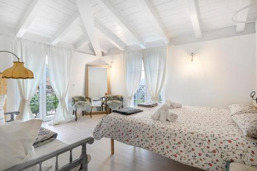 a bedroom with a bed in a room with windows at Anika’s Home in Valfloriana