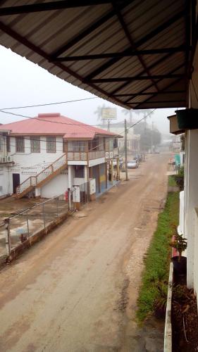 a dirt road in a small town with buildings at Don Santiago Guesthouse Downtown in San Ignacio