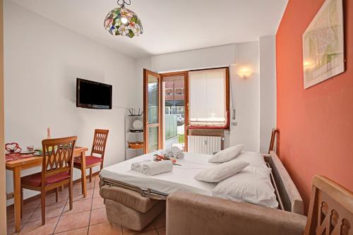 a bedroom with a bed and a dining room with a table at Bardonest - Central Studio in Bardonecchia - Happy Rentals in Bardonecchia