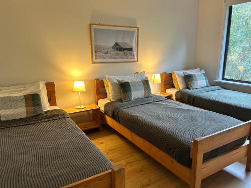 a room with two beds and two lamps in it at Turicum AT Monkey Rock Winery & Cider in Parryville