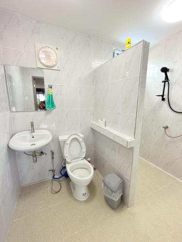 a bathroom with a toilet and a sink at NJ HOME Pool Villa in Ban Phe