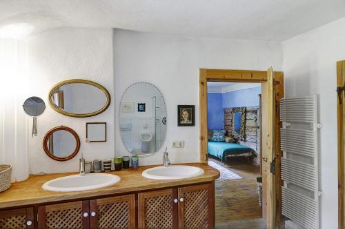a bathroom with two sinks and two mirrors at Ferienhaus Stadlerhof in Rettenschöss