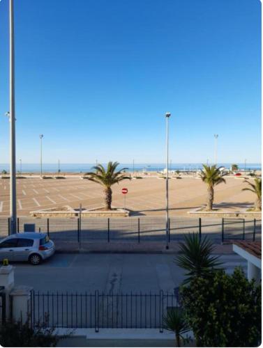 a car parked in a parking lot near the beach at Appartamenti Bramante in Vieste