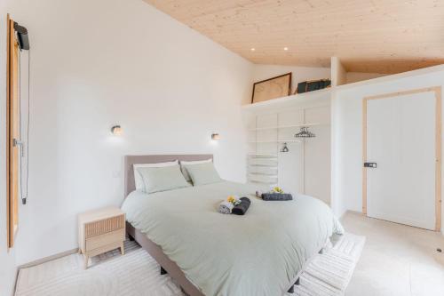 a bedroom with a large bed with two pillows on it at Grain d'Or - Proche Noirmoutier - Jardin in Bouin