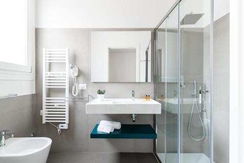 a bathroom with a sink and a glass shower at Aurà Guest House Iblea in Ragusa