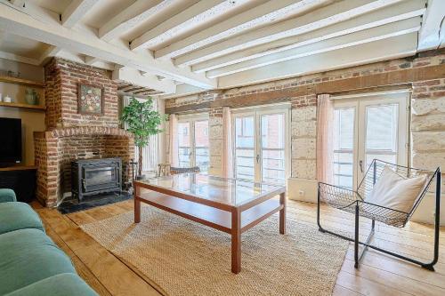 a living room with a table and a fireplace at Old Town - Lovely typical house in Lille