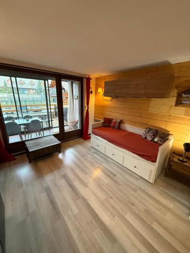 a bedroom with a bed with a wooden wall at Chez Arthur et Léa in La Joue du Loup