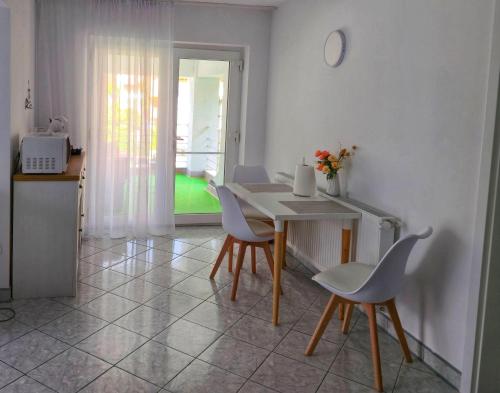 a kitchen with a table and chairs in a room at Ramhouse in Piteşti