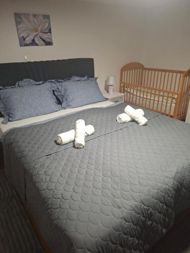 a bed with two towels on top of it at Apartman BECKER in Đakovo