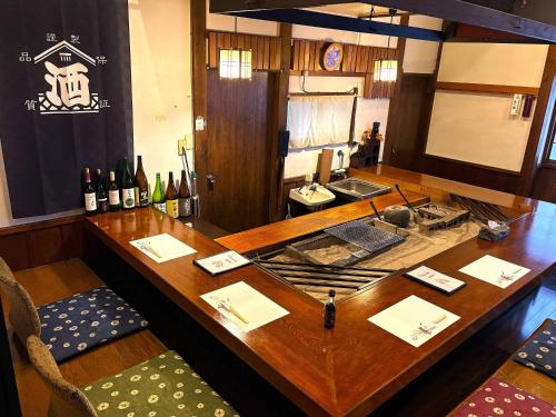 a wooden table with bottles of wine on it at Yuuzuru in Ito