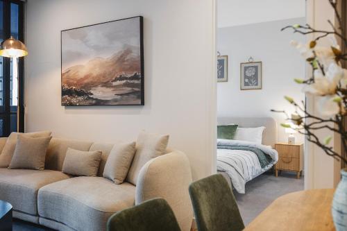 a living room with a couch and a bed at The Rush in Campbell